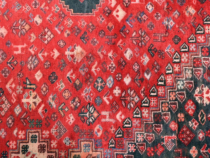a red rug with many different designs on it