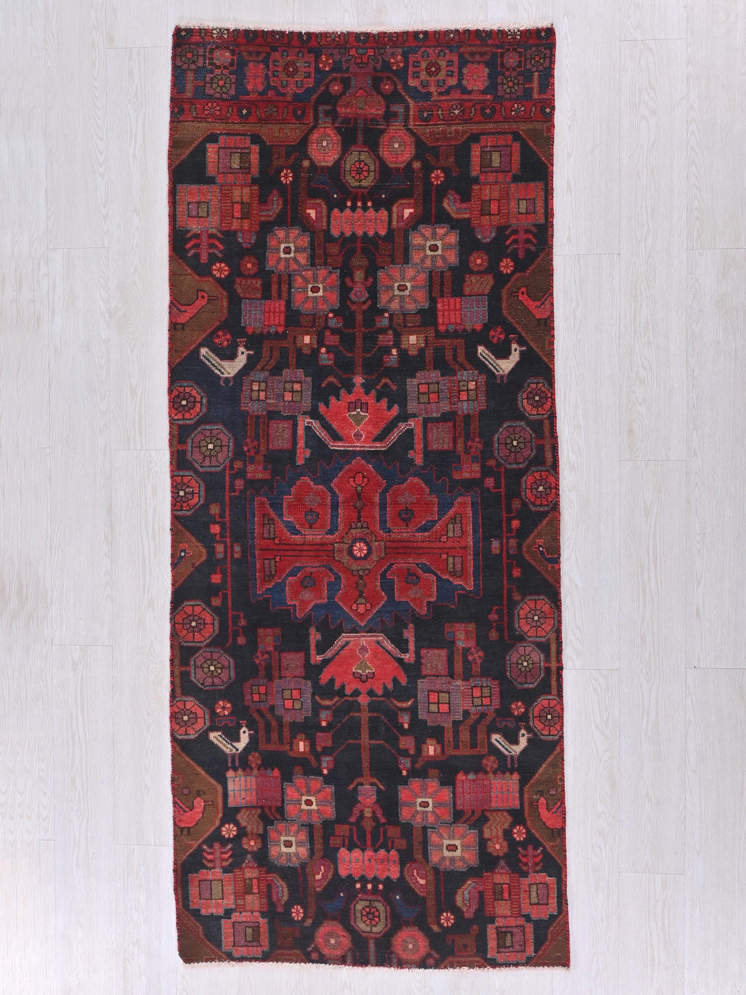 a red and black rug on a white floor