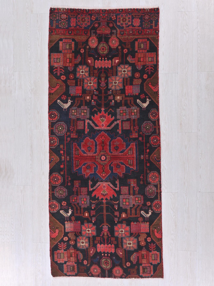 a red and black rug on a white floor