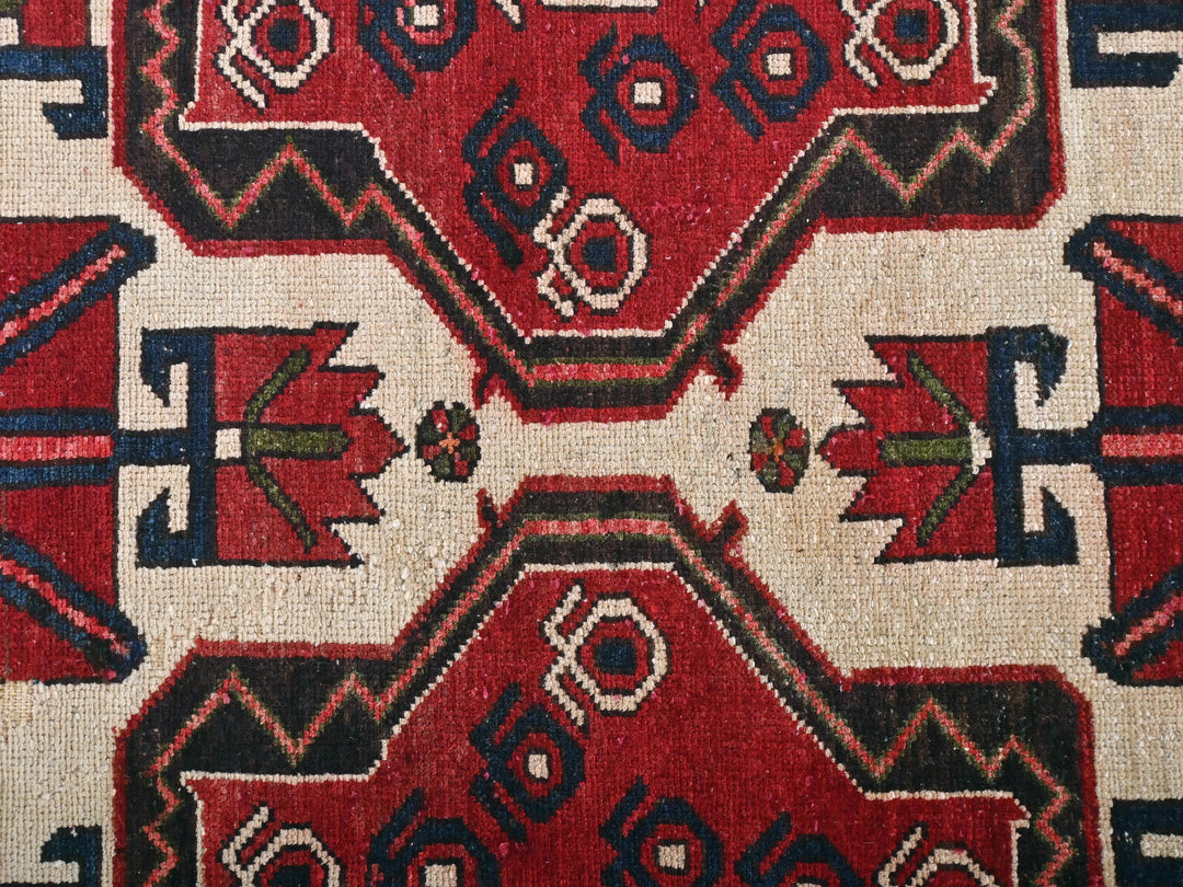a close up of a red and black rug