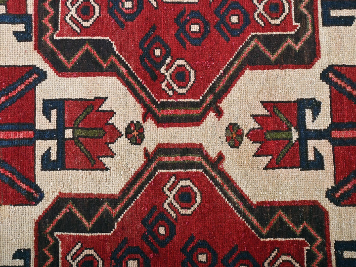 a close up of a red and black rug