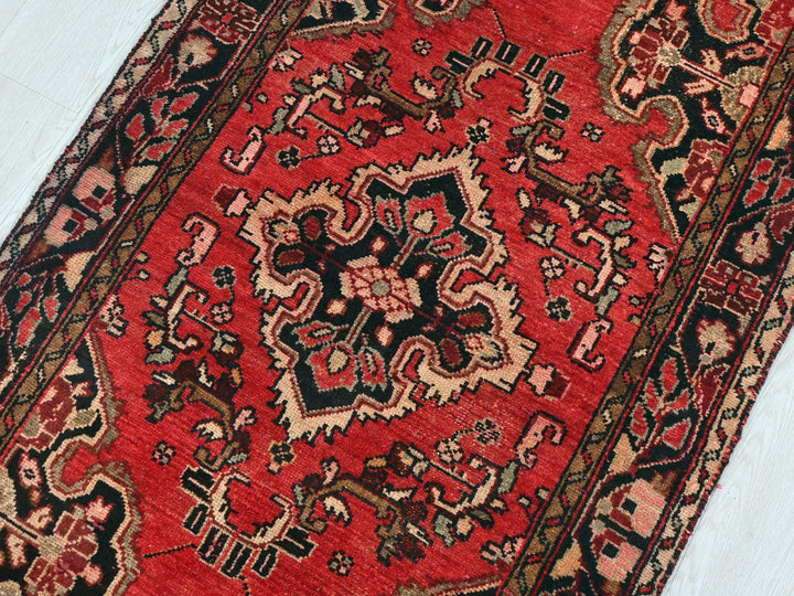 a red oriental rug on a white floor