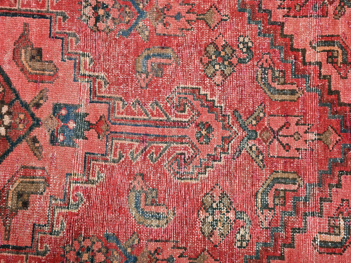 a red rug with a pattern on it