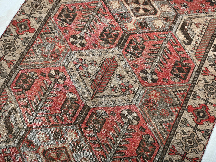 a red and black oriental rug on a white floor