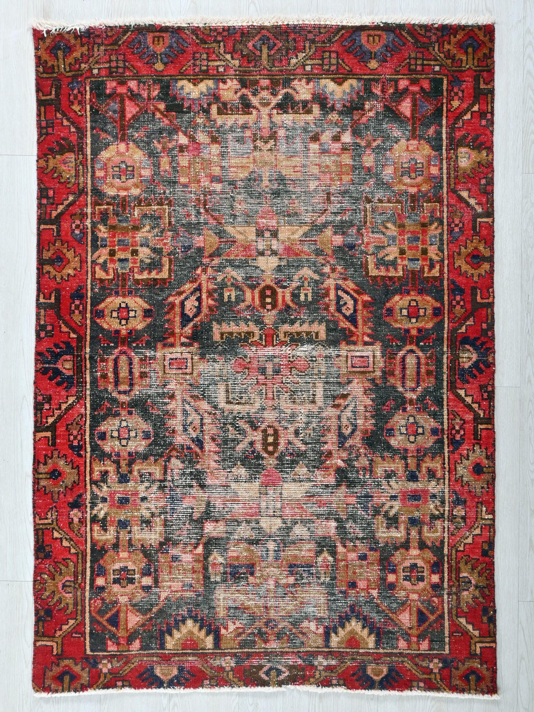 a red and blue rug on a white wall