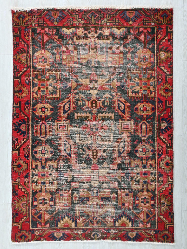 a red and blue rug on a white wall