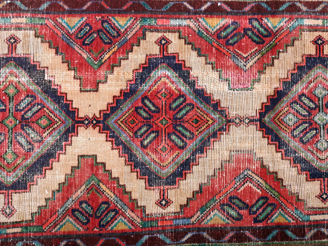 a red and blue rug with a pattern on it