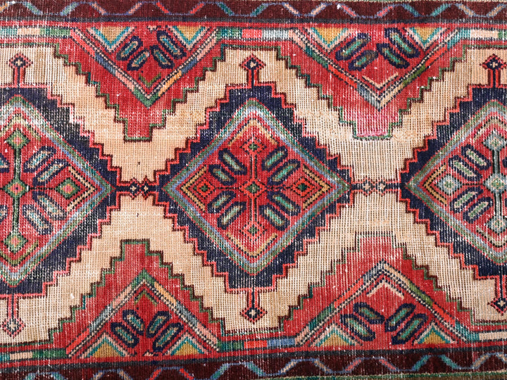 a red and blue rug with a pattern on it