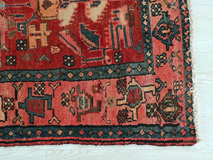 a red rug with an elephant design on it