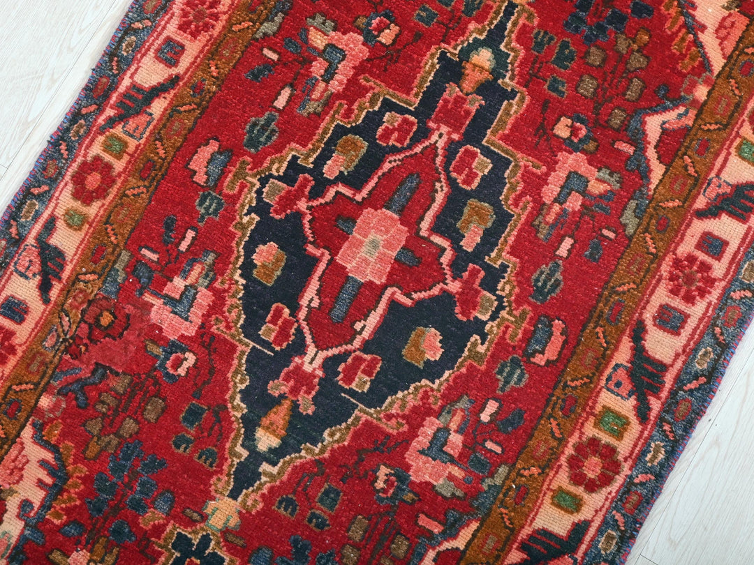 a red rug on a white wooden floor