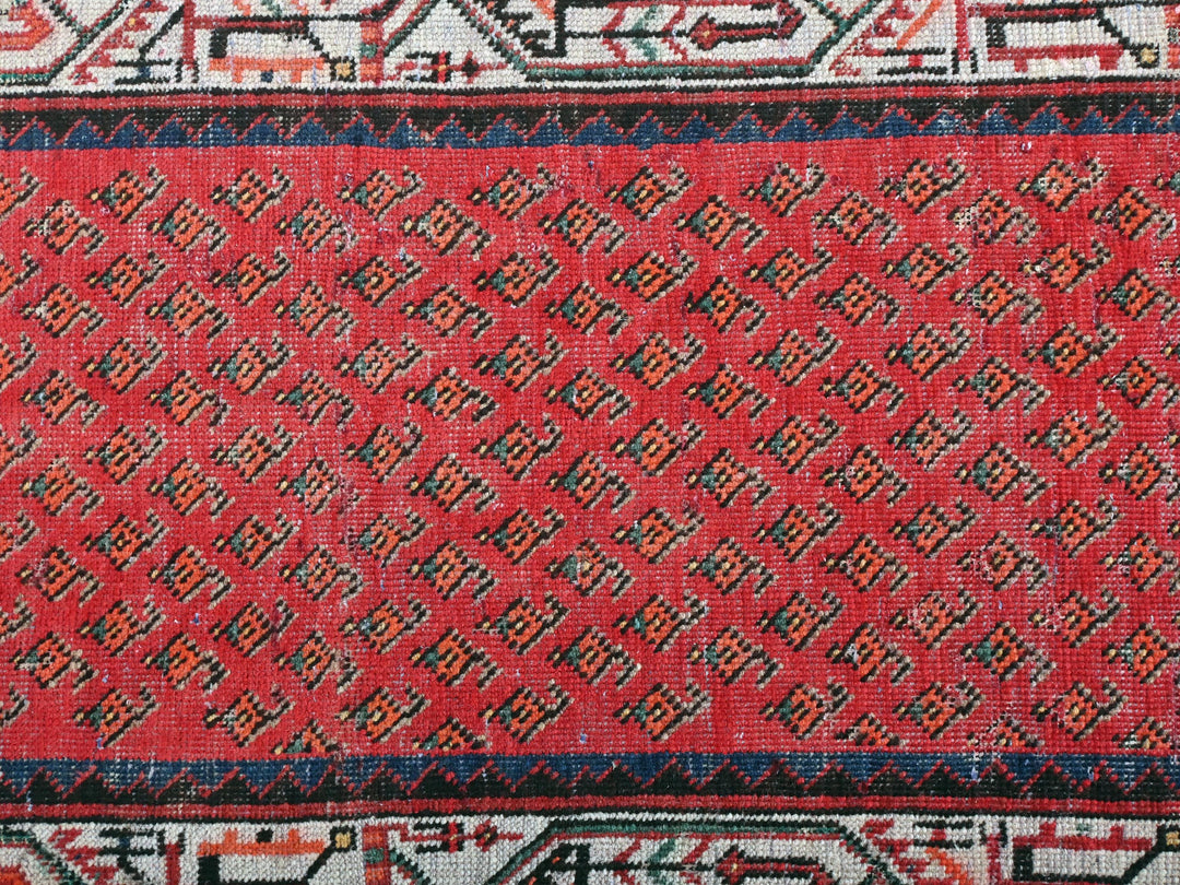 a close up of a red and black rug