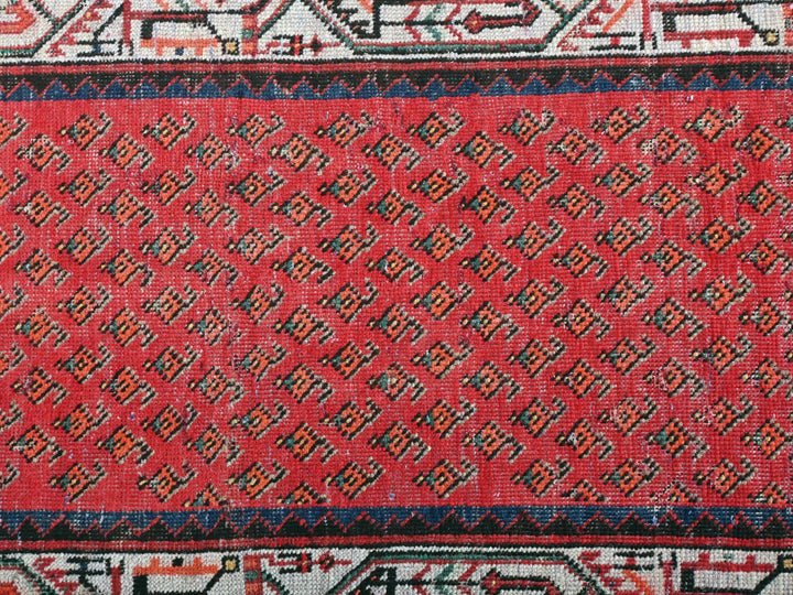 a close up of a red and black rug