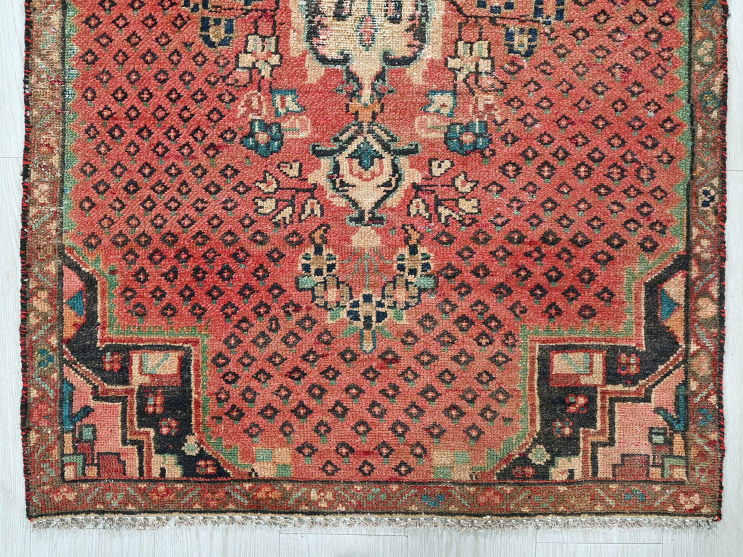 a red rug with an intricate design on it