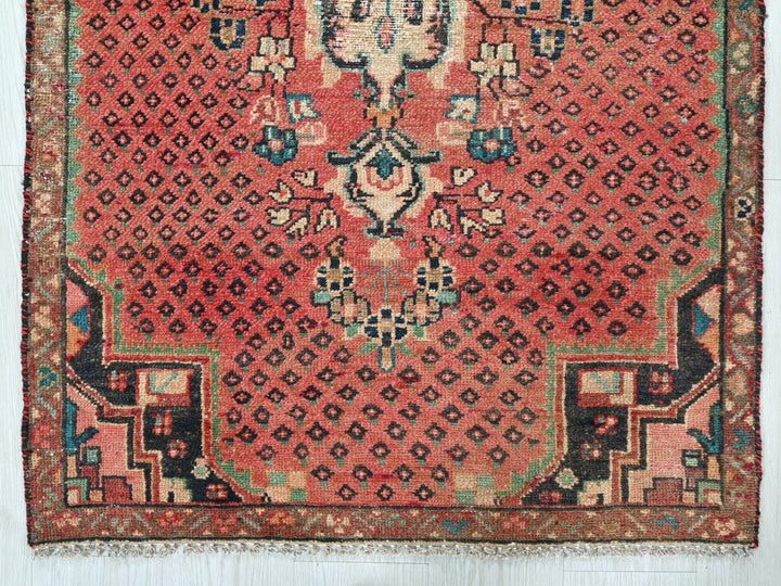 a red rug with an intricate design on it