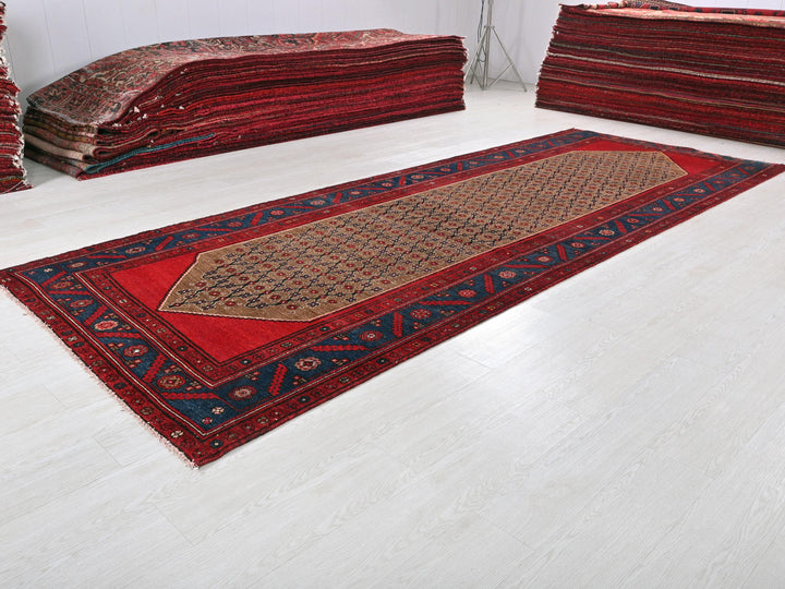 a pile of red rugs sitting on top of a white floor