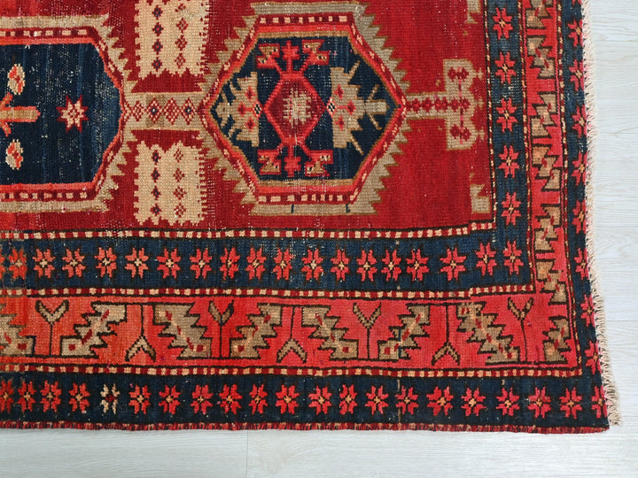 a red and blue rug with a design on it