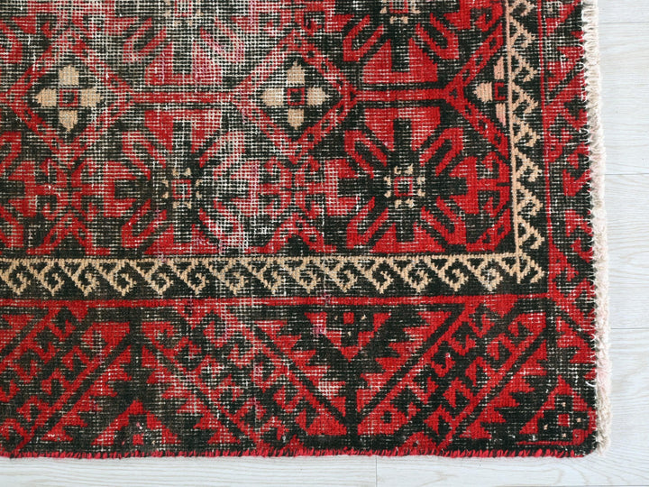 a close up of a red and black rug