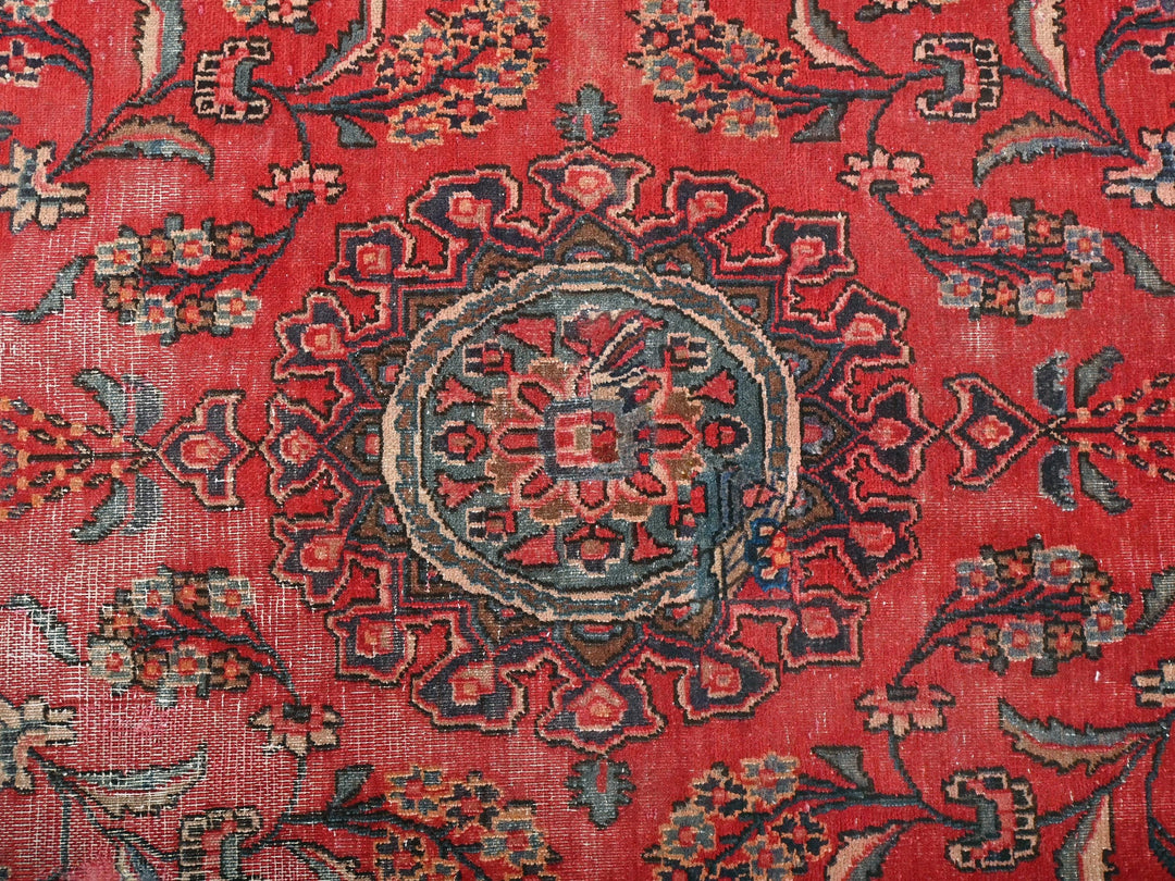 a red rug with a floral design on it