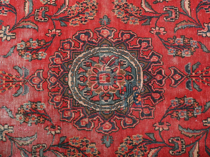 a red rug with a floral design on it