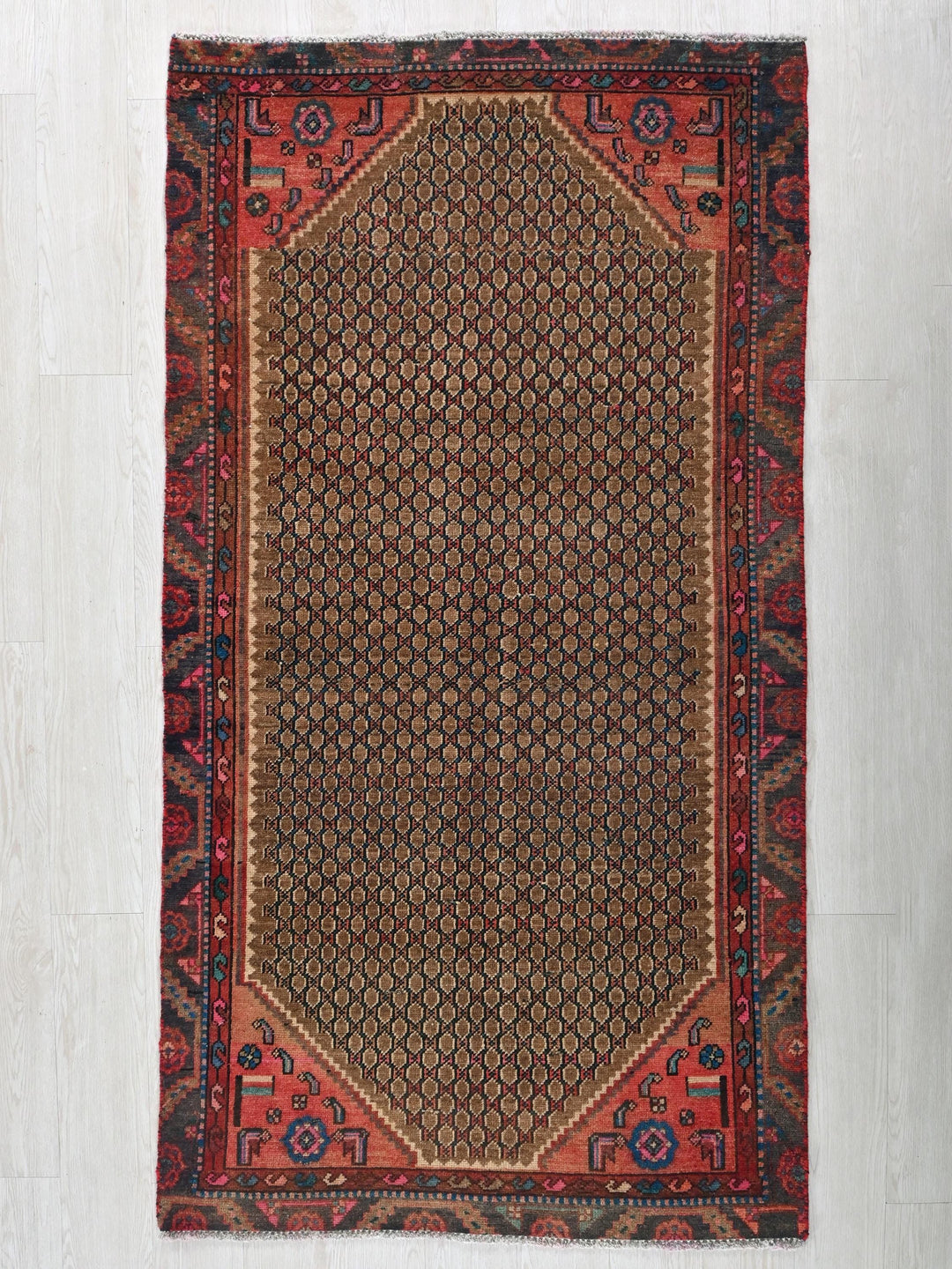 a red and blue rug on a white floor