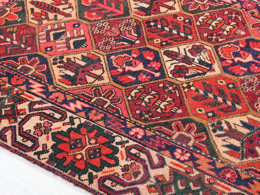 a red and blue oriental rug on a white floor