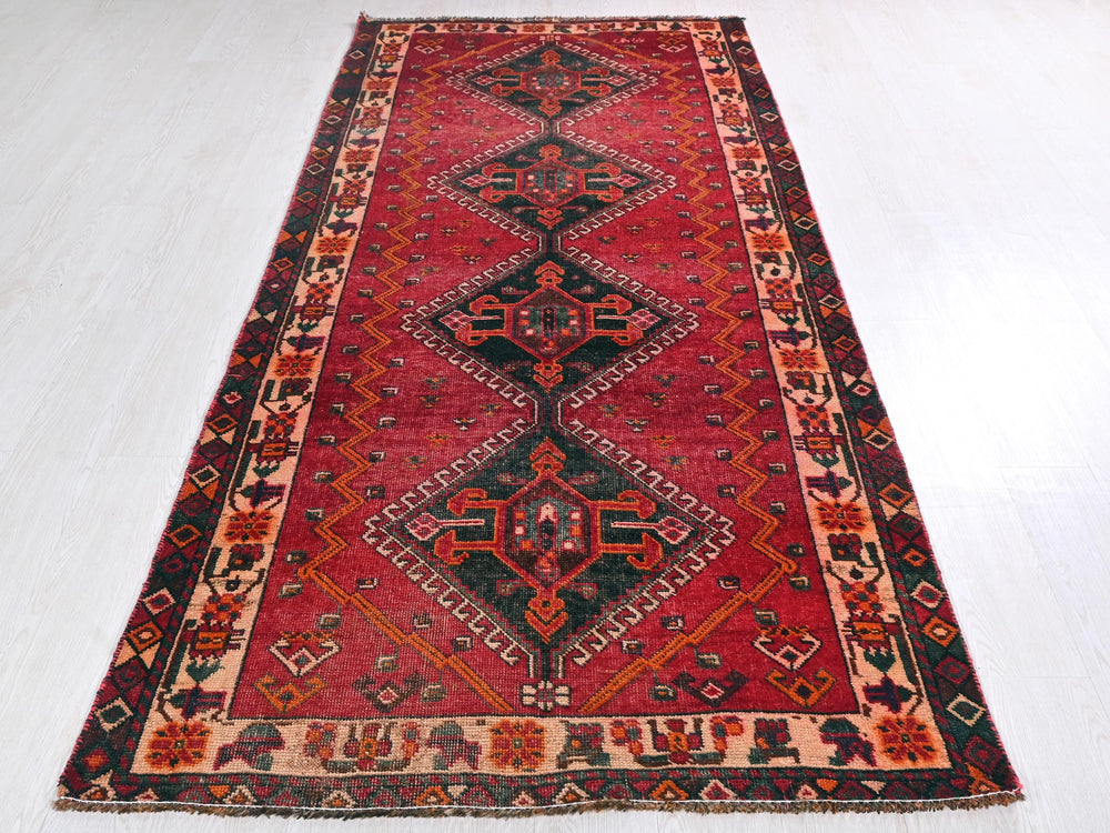 a red rug with a black and red design on it