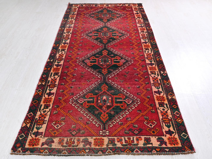 a red rug with a black and red design on it