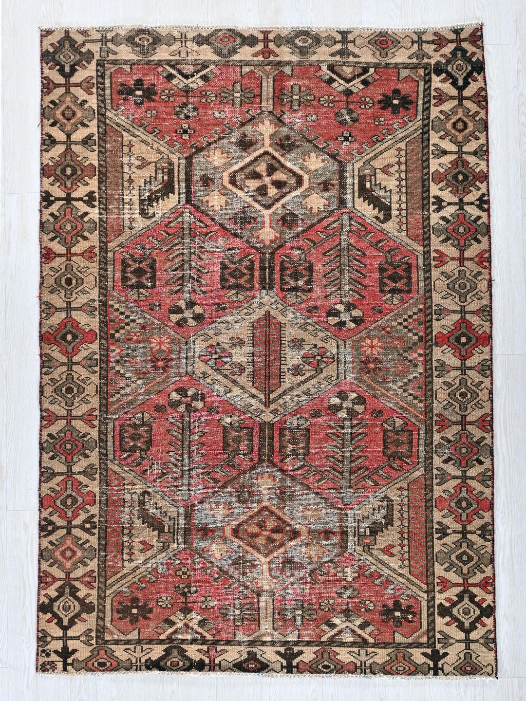 a red and black rug with a pattern on it