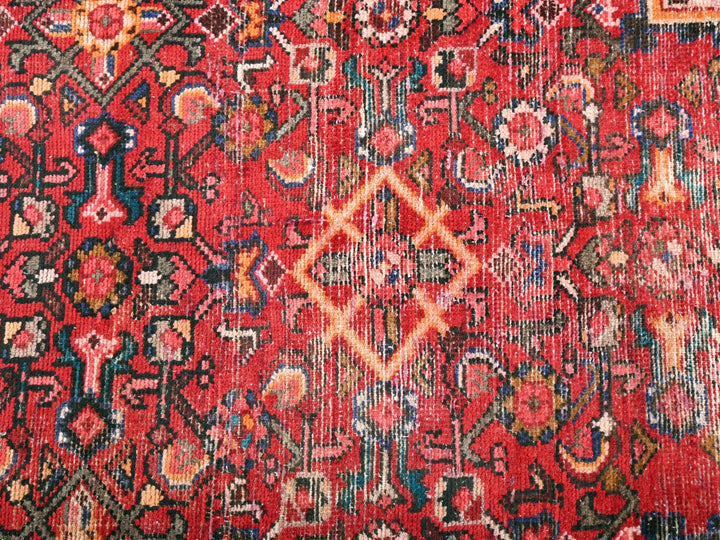 a red rug with a diamond design on it