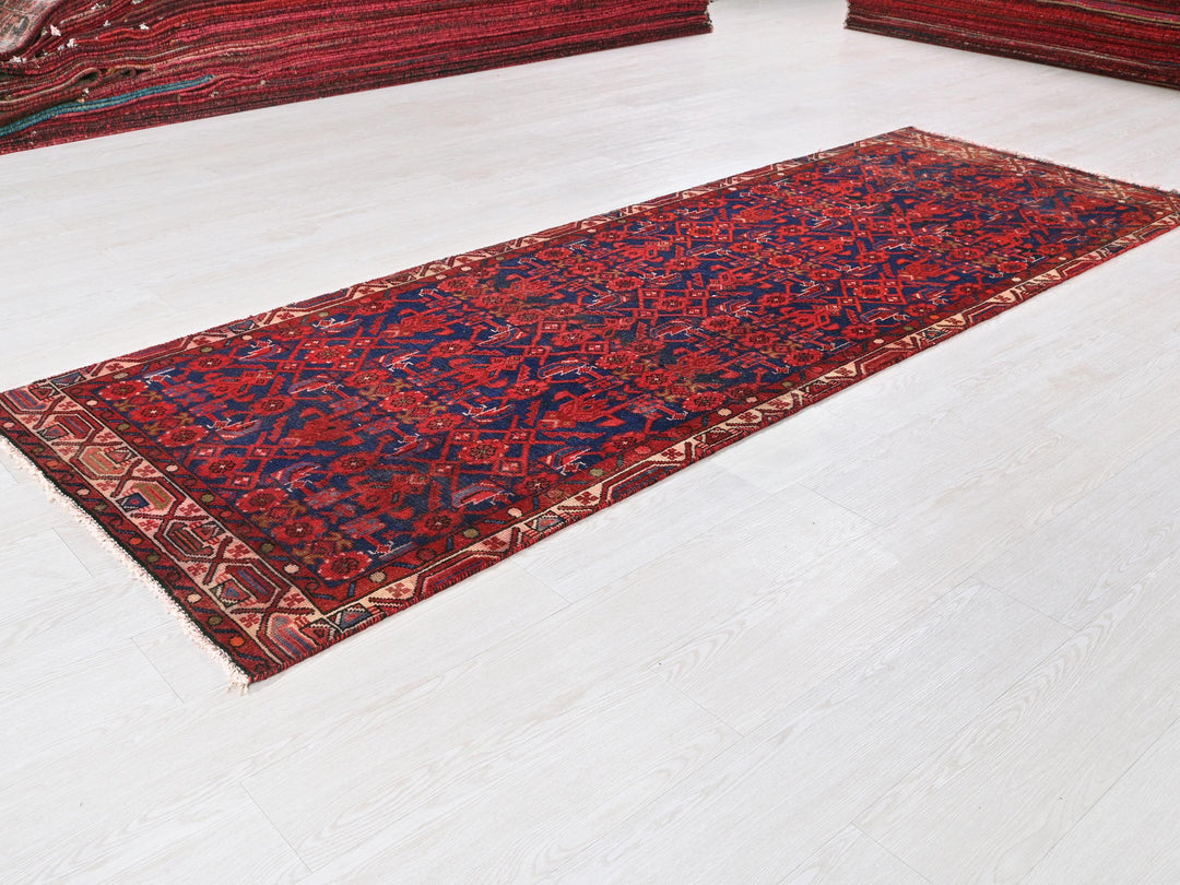 a red rug is laying on a white floor