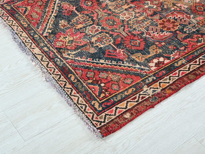 a red and blue rug on a white floor