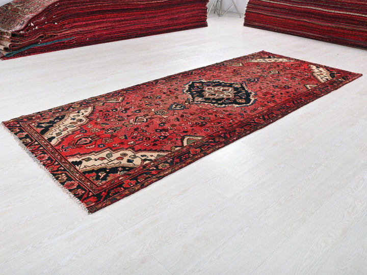 a red rug is laying on the floor