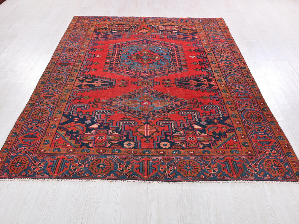 a red and blue rug on a white floor