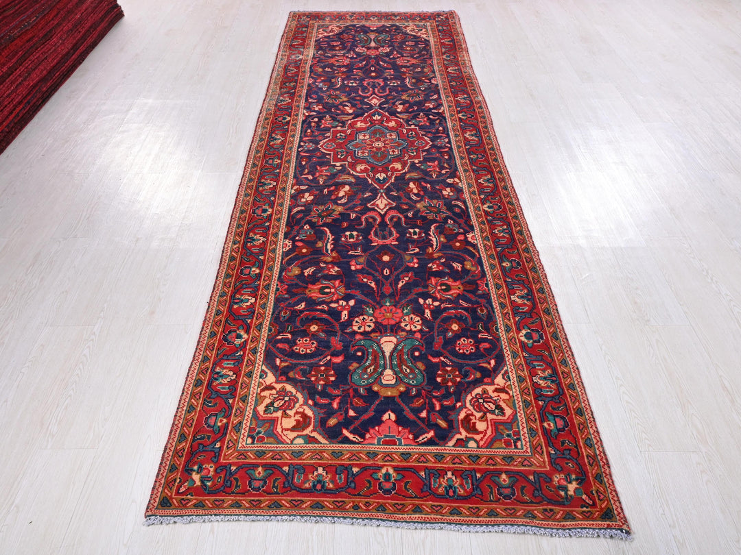 a red and blue rug on a white floor