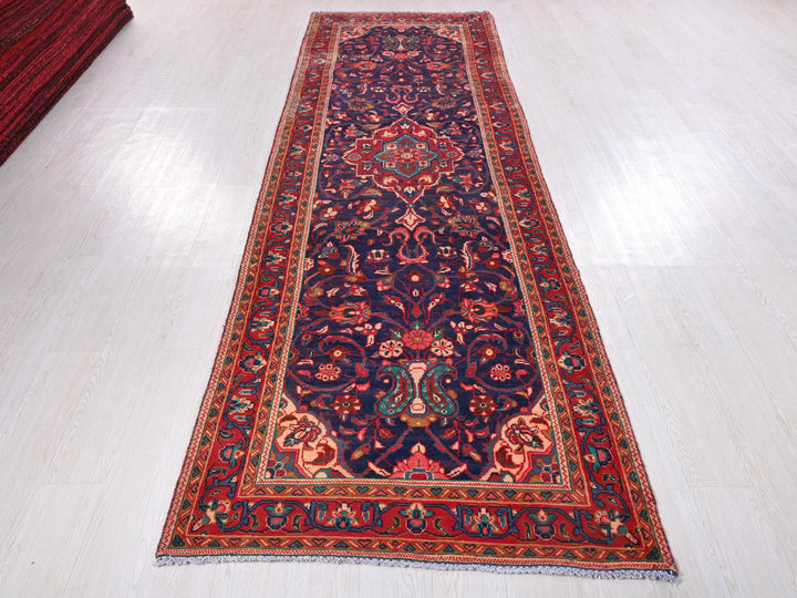 a red and blue rug on a white floor