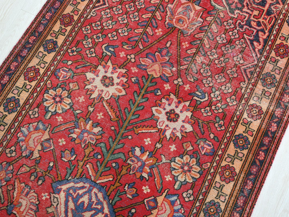 a red oriental rug on a white floor