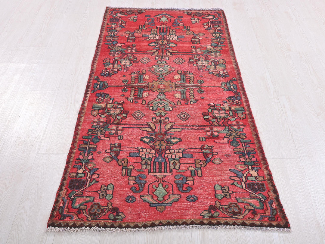 a red oriental rug on a white floor
