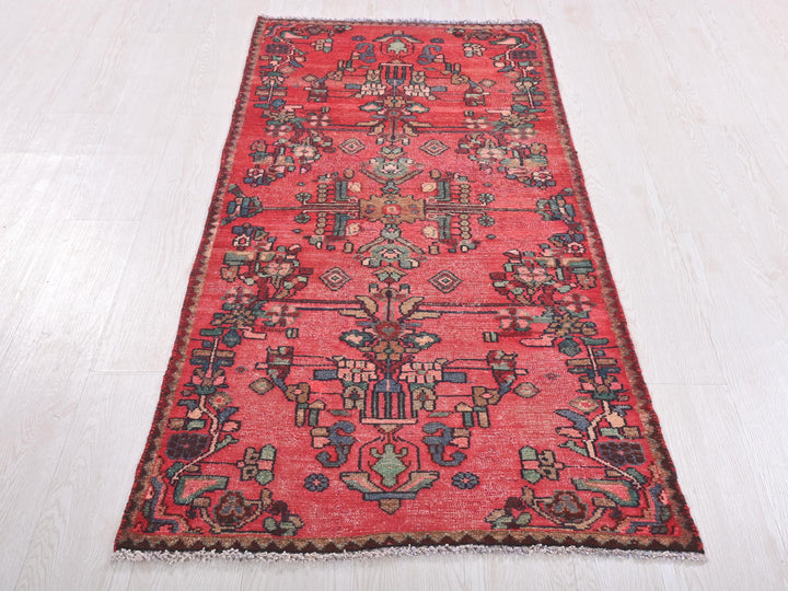 a red oriental rug on a white floor