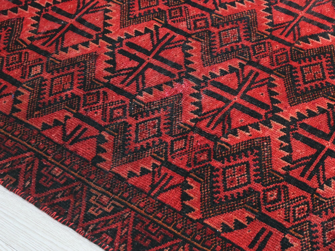 a close up of a red and black rug