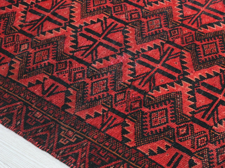 a close up of a red and black rug
