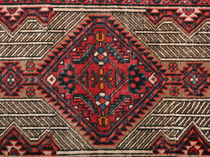 a close up of a red and black rug