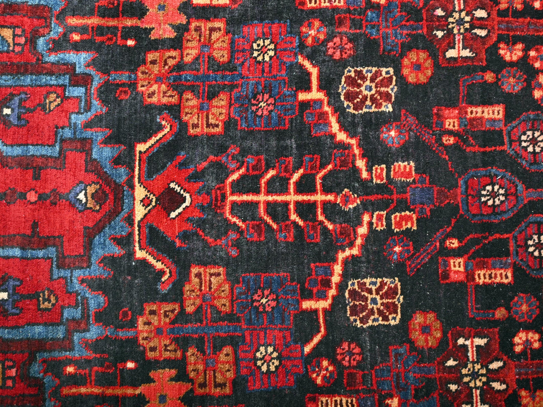 a red, blue, and black oriental rug