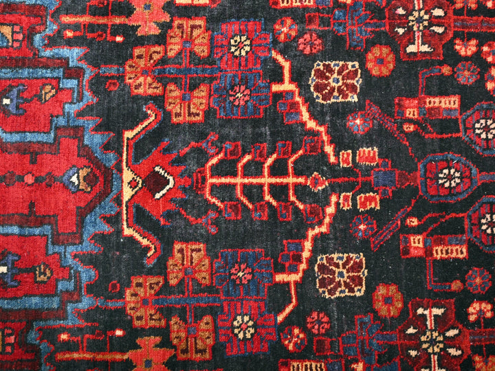 a red, blue, and black oriental rug