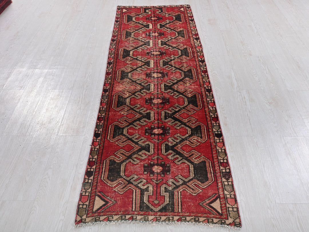 a long red rug on a white floor