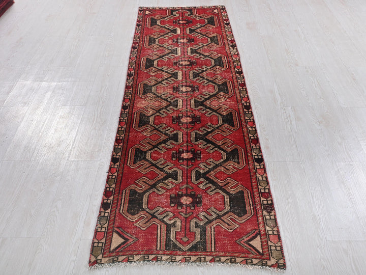 a long red rug on a white floor