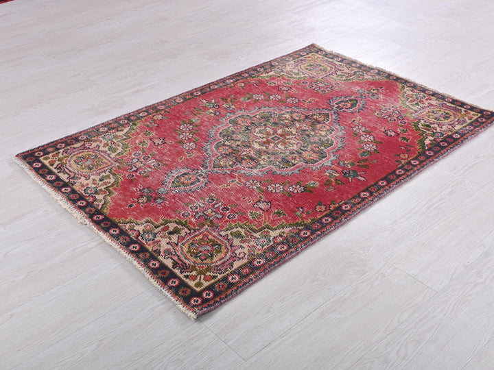 a red rug on the floor of a room