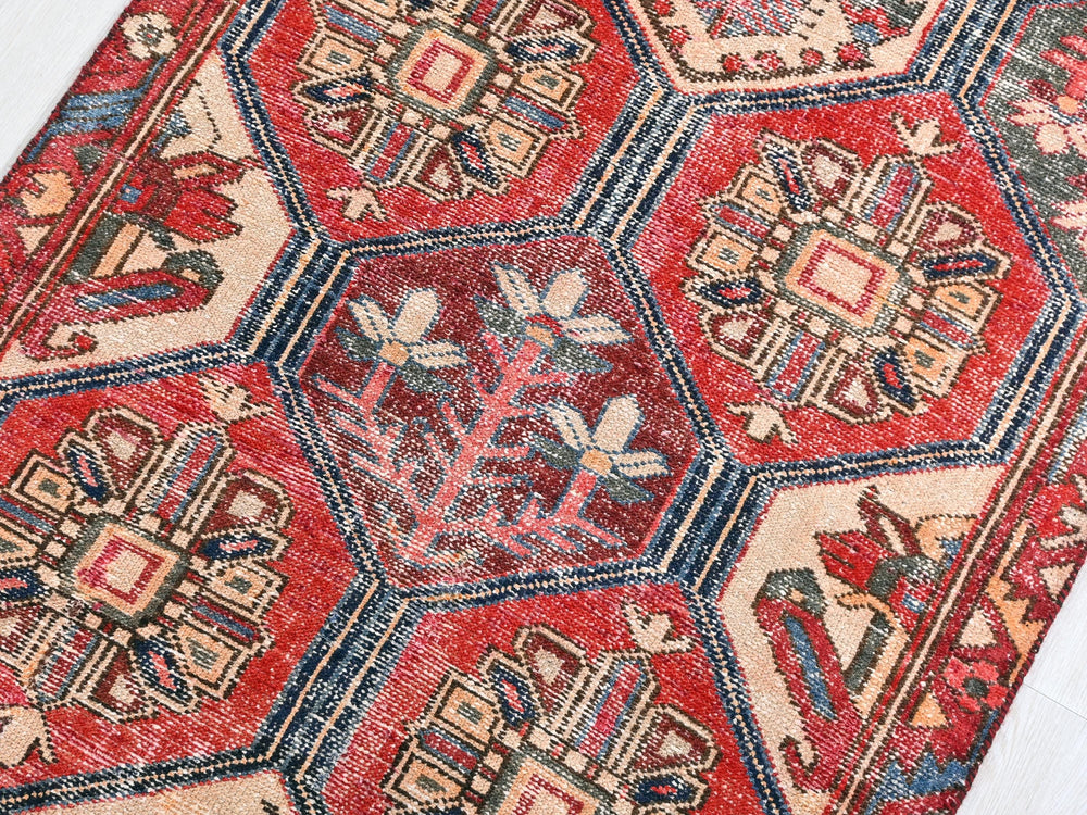 a red rug with many different designs on it