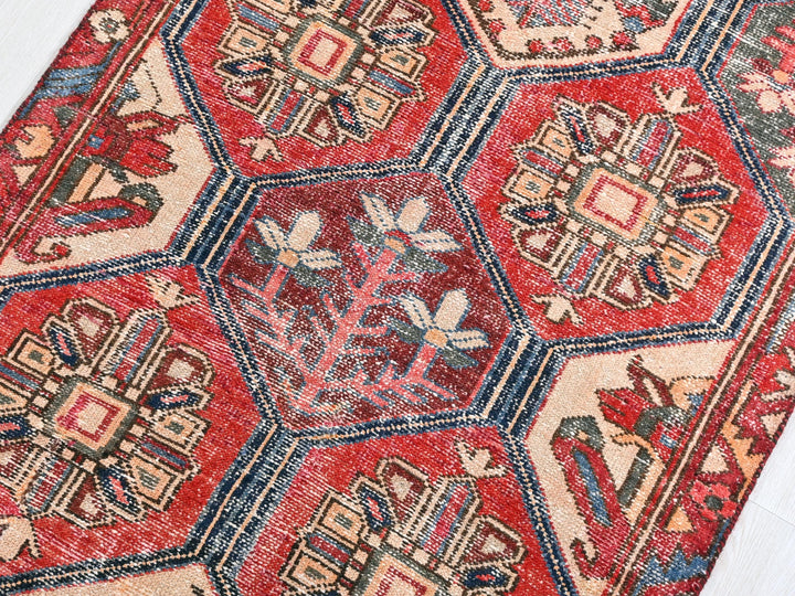a red rug with many different designs on it
