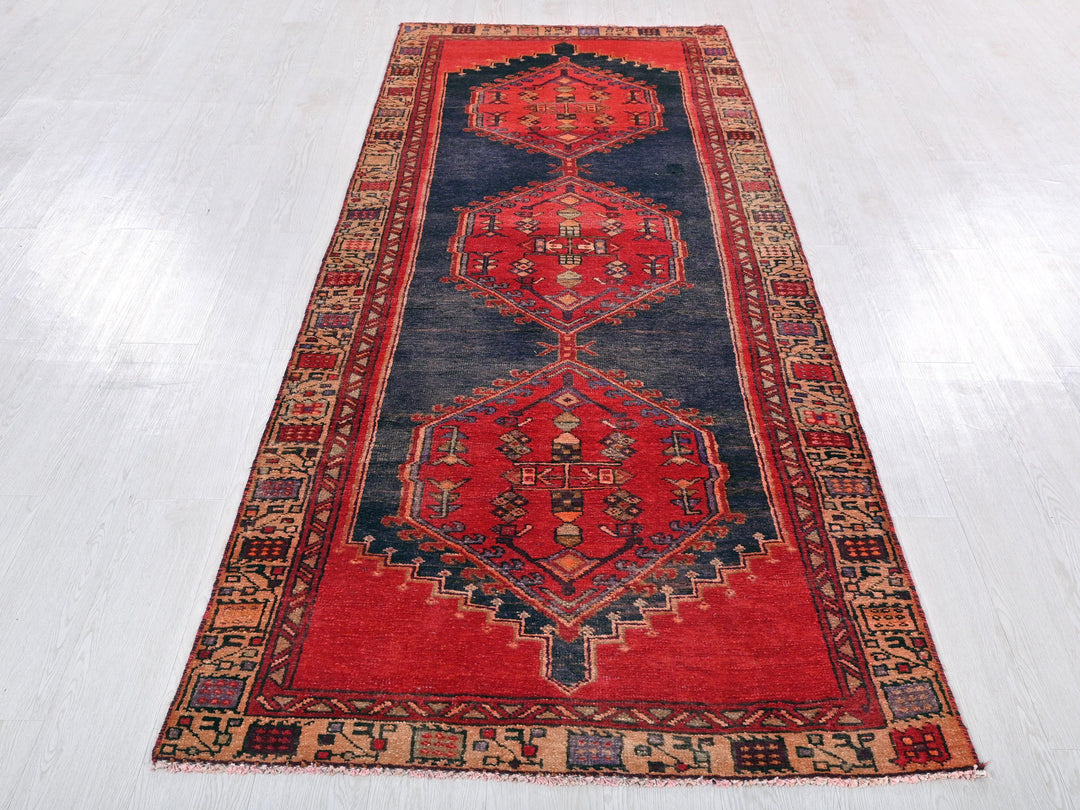 a red and blue rug on a white floor
