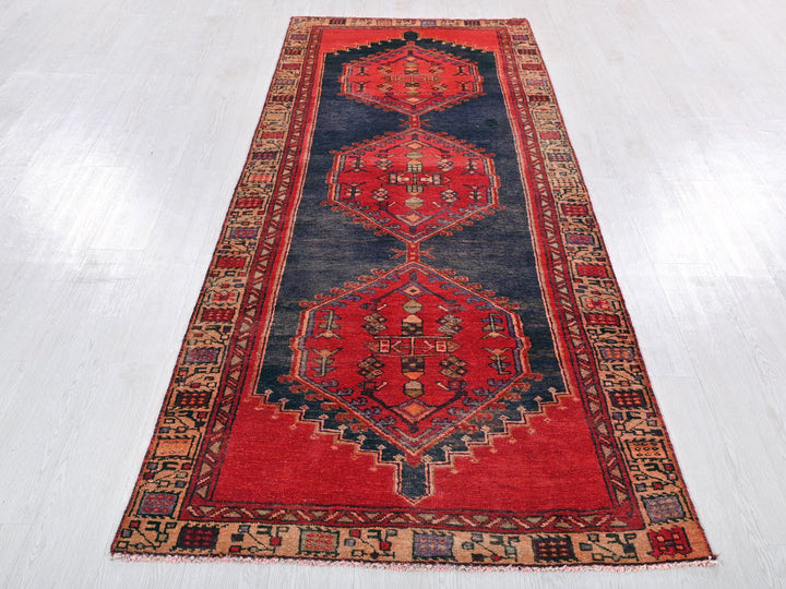 a red and blue rug on a white floor
